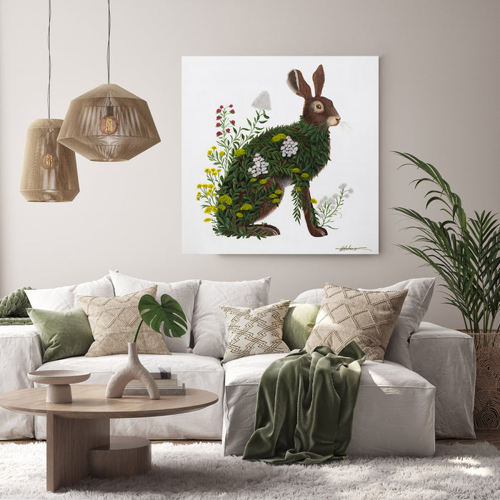 painting of a hare covered in green leaves and wild flowers on a white background