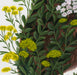 painting of a hare covered in green leaves and wild flowers on a white background