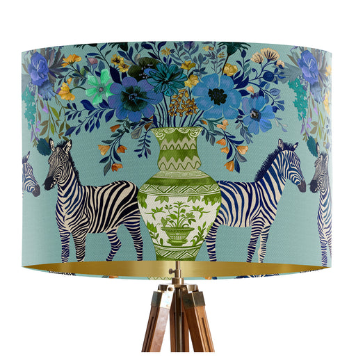 A maximalist design of Zebra's, chinoiserie vases and colourful flowers on a blue green mint backdrop on a classic sized 30x21cm handcrafted fabric lampshade by artist Kelly Stevens-McLaughlan