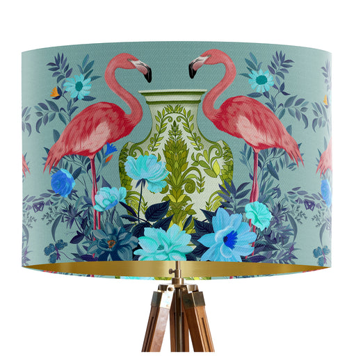 A maximalist design of pink flamingos, chinoiserie vases and colourful flowers on a blue green mint backdrop on a classic sized 30x21cm handcrafted fabric lampshade by artist Kelly Stevens-McLaughlan