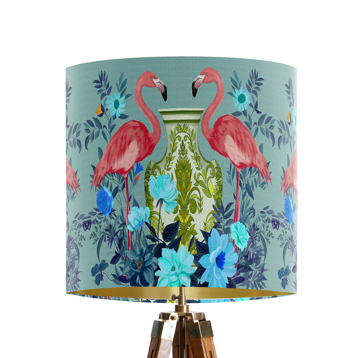 A maximalist design of pink flamingos, chinoiserie vases and colourful flowers on a blue green mint backdrop on a small sized 20x18cm handcrafted fabric lampshade by artist Kelly Stevens-McLaughlan