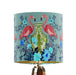 A maximalist design of pink flamingos, chinoiserie vases and colourful flowers on a blue green mint backdrop on a small sized 20x18cm handcrafted fabric lampshade by artist Kelly Stevens-McLaughlan