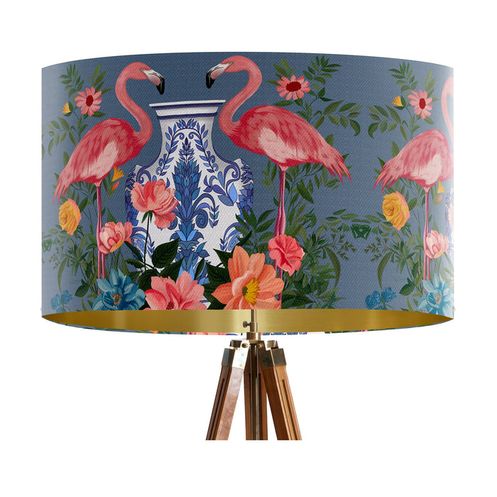 A maximalist design of pink flamingos, chinoiserie vases and colourful flowers on a blue backdrop on a large sized 40x25cm handcrafted fabric lampshade by artist Kelly Stevens-McLaughlan