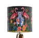 A maximalist design of pink flamingos, chinoiserie vases and colourful flowers on a charcoal backdrop on a small sized 20x18cm handcrafted fabric lampshade by artist Kelly Stevens-McLaughlan