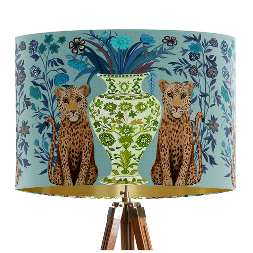 A maximalist design of leopards, chinoiserie vases and colourful flowers on a blue green mint backdrop on a classic sized 30x21cm handcrafted fabric lampshade by artist Kelly Stevens-McLaughlan