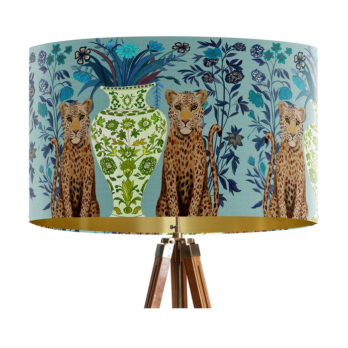 A maximalist design of leopards, chinoiserie vases and colourful flowers on a blue green mint backdrop on a large sized 40x25cm handcrafted fabric lampshade by artist Kelly Stevens-McLaughlan