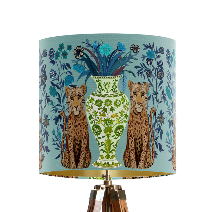 A maximalist design of leopards, chinoiserie vases and colourful flowers on a blue green mint backdrop on a small sized 20x18cm handcrafted fabric lampshade by artist Kelly Stevens-McLaughlan