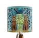 A maximalist design of leopards, chinoiserie vases and colourful flowers on a blue green mint backdrop on a small sized 20x18cm handcrafted fabric lampshade by artist Kelly Stevens-McLaughlan