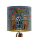 A maximalist design of leopards, chinoiserie vases and colourful flowers on a blue backdrop on a small sized 20x18cm handcrafted fabric lampshade by artist Kelly Stevens-McLaughlan