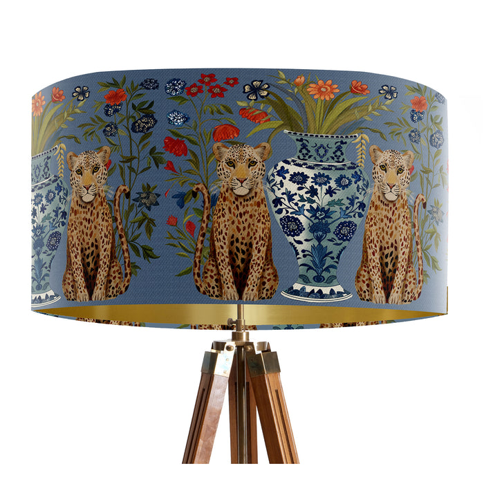 A maximalist design of leopards, chinoiserie vases and colourful flowers on a blue backdrop on a Extra large sized 45x25cm handcrafted fabric lampshade by artist Kelly Stevens-McLaughlan