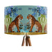 A maximalist design of tigers, chinoiserie vases and colourful flowers on a blue green mint backdrop on a large sized 40x25cm handcrafted fabric lampshade by artist Kelly Stevens-McLaughlan