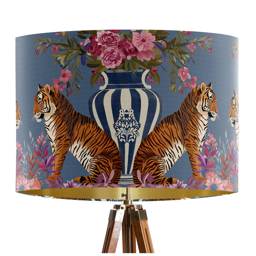 A maximalist design of tigers, chinoiserie vases and colourful flowers on a blue backdrop on a classic sized 30x21cm handcrafted fabric lampshade by artist Kelly Stevens-McLaughlan