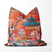 Burnt orange cushion with blue pagoda and floral pattern.