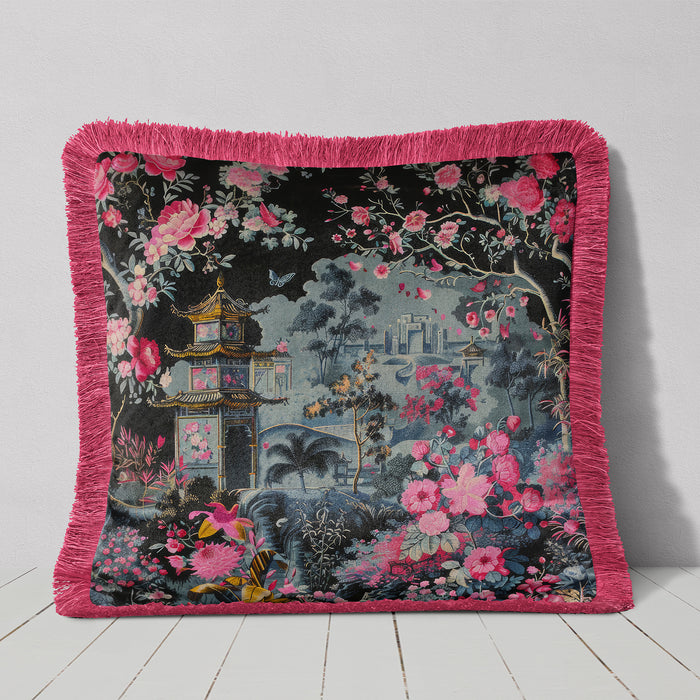 Black velvet cushion with pink fringe and a pagoda surrounded by pink and magenta flowers