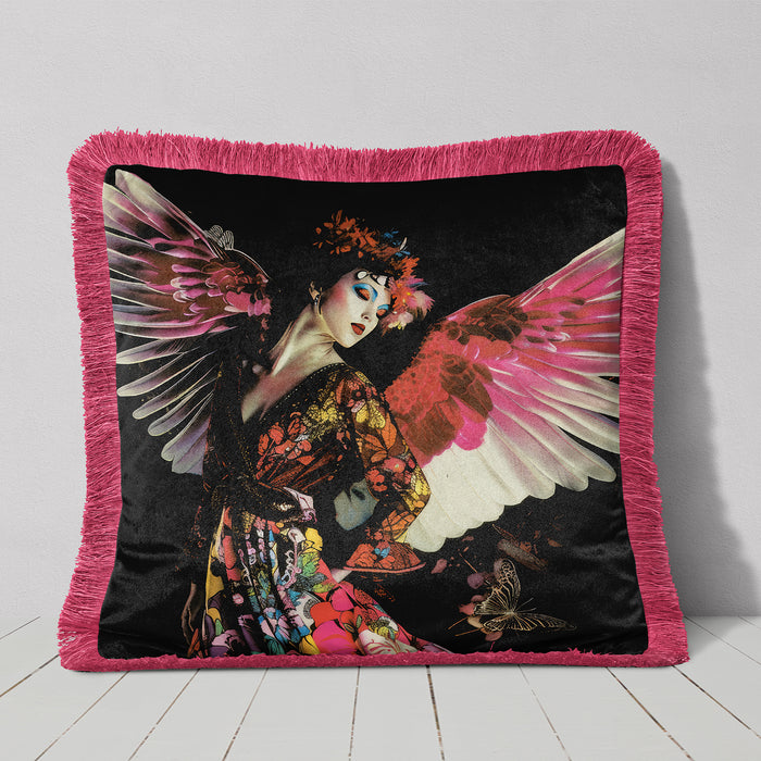 Luxury velvet cushion pillow cover of a woman with vibrant pink wings, wearing a floral dress and flower crown, set against a dark background with a butterfly motif. The pillow has a pink fringe border.