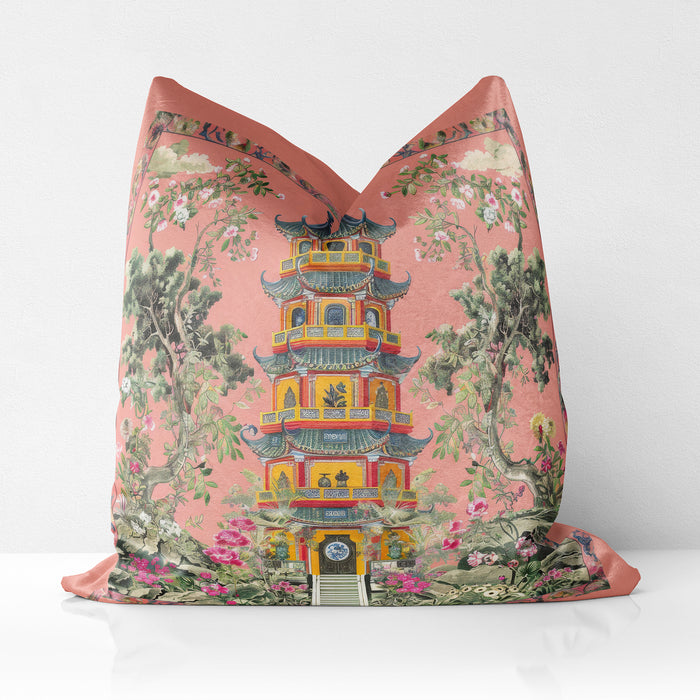 Velvet coral cushion with a pagoda and delicate floral accents.