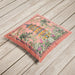 Velvet coral cushion with a pagoda and delicate floral accents.