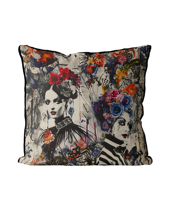 Striking decorative cushion, a fusion of gothic and bohemian styles. Two monochromatic women adorned with elaborate floral headdresses and butterflies splashed in vibrant colours, a dramatic and enchanting visual effect combining gothic elegance with bohemian flair.