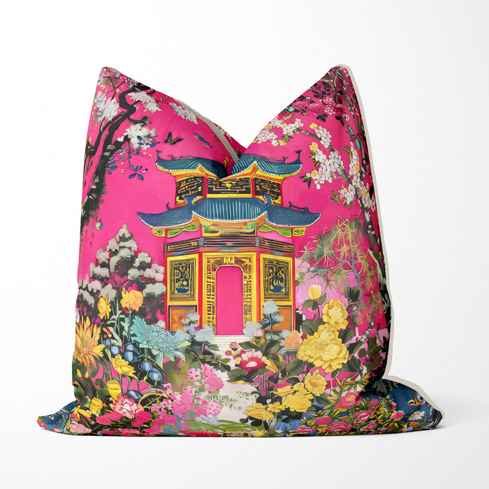 Bright pink cushion with a pagoda and lush floral design.