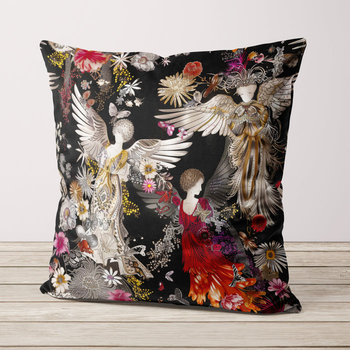 Luxury velvet cushion pillow cover featuring three ethereal figures with wings, adorned in golden, silver, and red flowing gowns, set against a dark background with floral and intricate patterns.