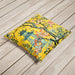 Yellow velvet cushion with pagoda and blooming flowers in a floral landscape.