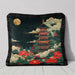 Dark velvet cushion featuring a pagoda illuminated by a golden moon and surrounded by florals with a fringed edge.