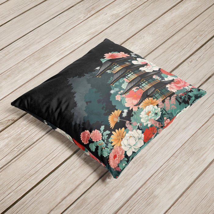 Velvet cushion featuring a pagoda surrounded by florals on a black background.