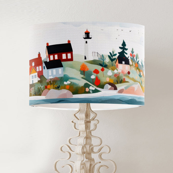 A vibrant whimsical Scandinavian coastal village design on a classic sized 30x21cm handcrafted fabric lampshade by artist Kelly Stevens-McLaughlan