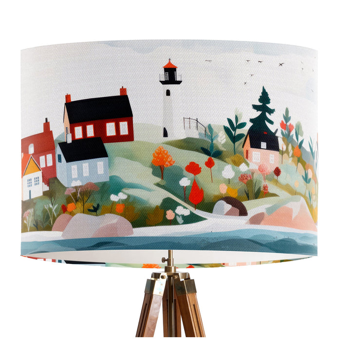 A vibrant whimsical Scandinavian coastal village design on a classic sized 30x21cm handcrafted fabric lampshade by artist Kelly Stevens-McLaughlan