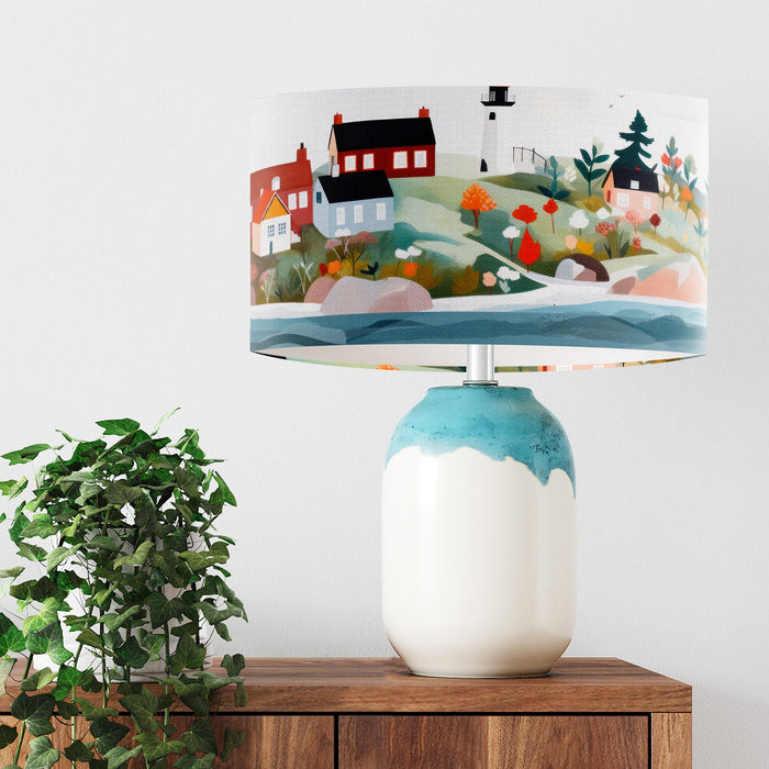 A vibrant whimsical Scandinavian coastal village design on a Extra large sized 45x25cm handcrafted fabric lampshade by artist Kelly Stevens-McLaughlan