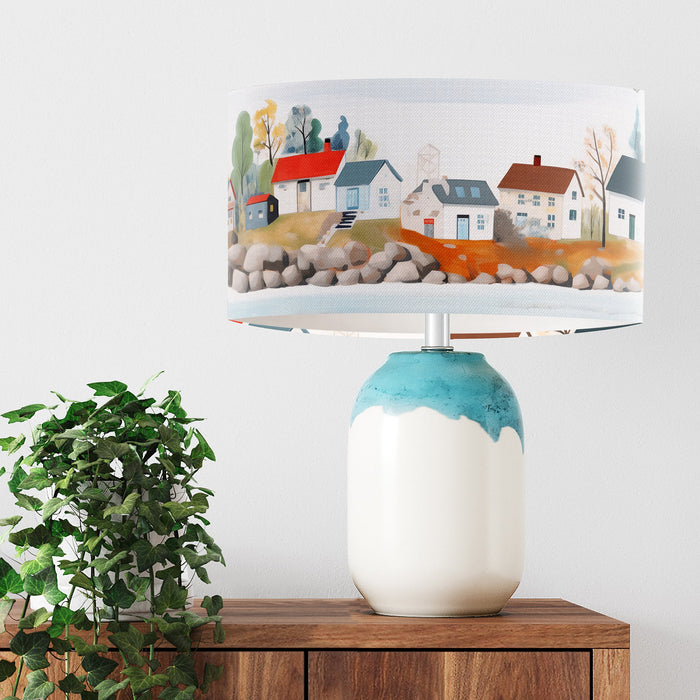 A vibrant whimsical Scandinavian coastal village design on a Extra large sized 45x25cm handcrafted fabric lampshade by artist Kelly Stevens-McLaughlan