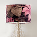 Pink and taupe tropical leaves and flowers, a lively design on a classic sized 30x21cm handcrafted fabric lampshade by artist Kelly Stevens-McLaughlan