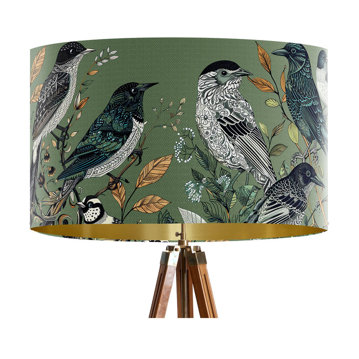 Intricately drawn birds, sit on branches and leaves with a green backdrop on a large sized 40x25cm handcrafted fabric lampshade by artist Kelly Stevens-McLaughlan