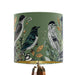 Intricately drawn birds, sit on branches and leaves with a yellow backdrop on a small sized 20x18cm handcrafted fabric lampshade by artist Kelly Stevens-McLaughlan