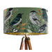 Intricately drawn birds, sit on branches and leaves with a green backdrop on a Extra large sized 45x25cm handcrafted fabric lampshade by artist Kelly Stevens-McLaughlan