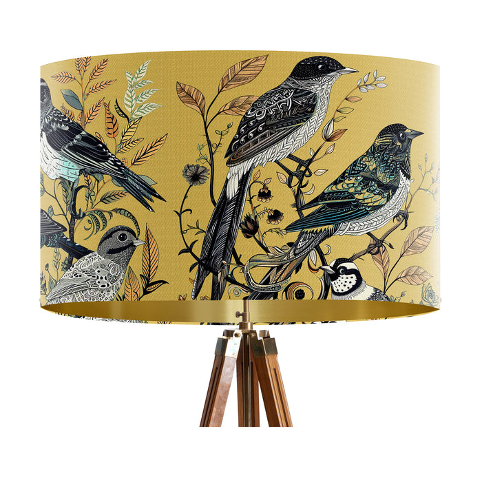 Intricately drawn birds, sit on branches and leaves with a yellow backdrop on a large sized 40x25cm handcrafted fabric lampshade by artist Kelly Stevens-McLaughlan