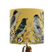 Intricately drawn birds, sit on branches and leaves with a yellow backdrop on a small sized 20x18cm handcrafted fabric lampshade by artist Kelly Stevens-McLaughlan