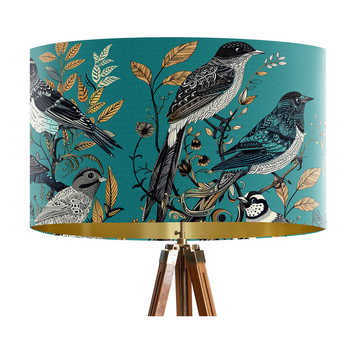 Intricately drawn birds, sit on branches and leaves with a blue backdrop on a large sized 40x25cm handcrafted fabric lampshade by artist Kelly Stevens-McLaughlan