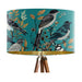 Intricately drawn birds, sit on branches and leaves with a blue backdrop on a large sized 40x25cm handcrafted fabric lampshade by artist Kelly Stevens-McLaughlan