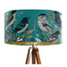 Intricately drawn birds, sit on branches and leaves with a blue backdrop on a Extra large sized 45x25cm handcrafted fabric lampshade by artist Kelly Stevens-McLaughlan