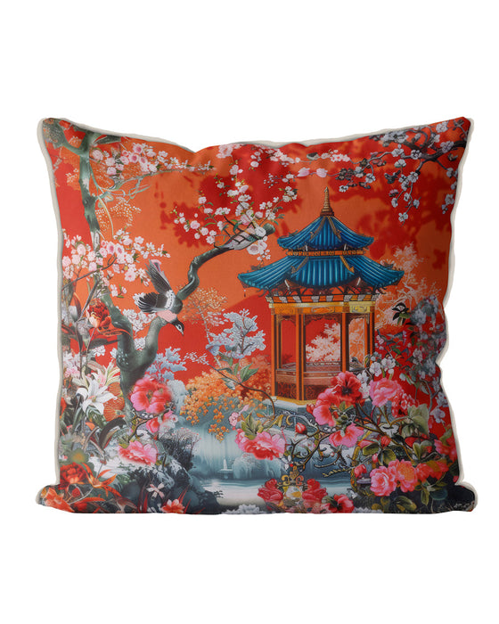 Burnt orange cushion with blue pagoda and floral pattern.