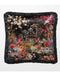 Black cushion with fringed edge, featuring a pagoda and lush floral accents.