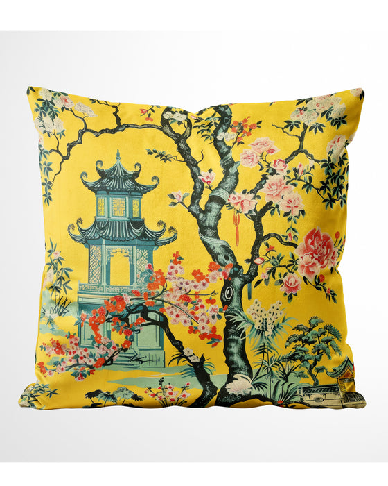 Yellow velvet cushion with pagoda and blooming flowers in a floral landscape.